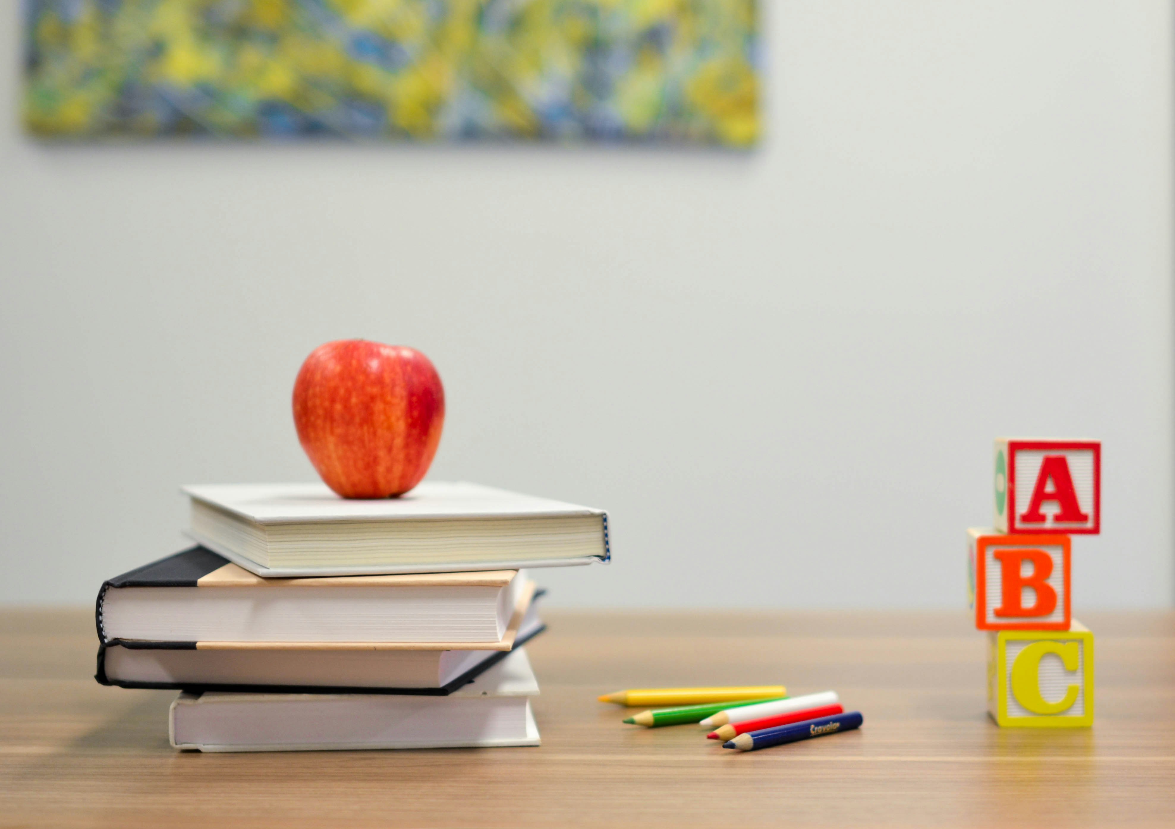 Educational setup with books, an apple, and ABC blocks